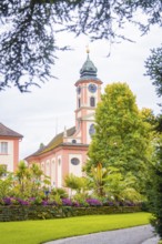 Historic church with beautiful garden in the foreground, Mainau flower island, Lake Constance,