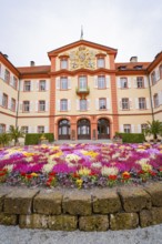 Symmetrical palace view with magnificent, colourful flowers, Mainau flower island, Lake Constance,