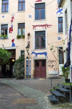 House facade with pictures, trendy neighbourhood in Neustadt, Dresden, Saxony, Germany