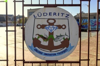 Town coat of arms on a fence, Lüderitz, Karas region, Namibia