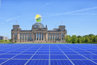 Symbolic image, solar park in the city, Reichstag building Berlin with environmental logo, modules