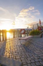A sunny evening by the lake with an empty bench and a picturesque promenade, Überlingen, Lake