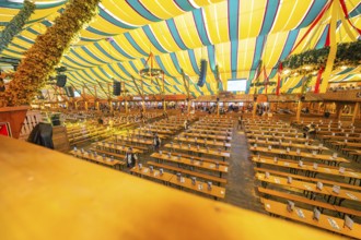 Large marquee with colourful stripes and traditional interior design, Cannstatter Wasen folk