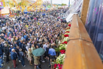 Large crowds at a colourful festival with a cheerful atmosphere, Cannstatter Wasen folk festival,