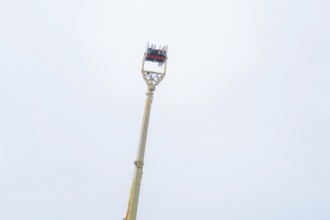 An attraction with people and a wide view of the sky, Cannstatter Wasen fair, Stuttgart, Germany
