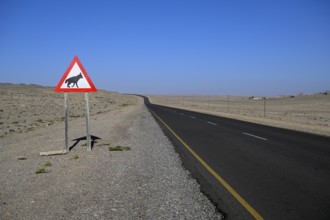 Sign warning of brown hyenas or beach wolves (Parahyaena brunnea) near Lüderitz, Karas Region,