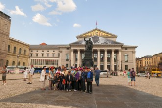 Japanese tourist group in front of the King Max I Joseph Monument. In the back National Theatre