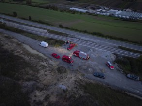 Aerial view of rescue vehicles and personnel near railway tracks and roads, fire drill in the new
