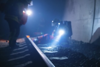 Firefighters use torches on tracks in a tunnel, firefighting exercise in the new construction