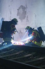 Firefighters provide first aid on tracks in a tunnel, firefighting exercise in the new tunnel of