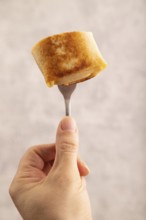 Fried crispy pancakes with meat and cheese with hand. side view, close up, selective focus