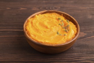 Sweet potato porridge in wooden bowl on wooden background. Diet, healthy eating concept. side view,