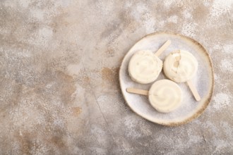 ?hocolate Ice cream in white glaze, on brown concrete background, top view, flat lay, copy space,