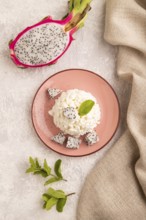 White ?ottage cheese, Curd, with Pithaya on gray concrete background and linen textile, top view,