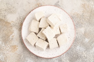Coffee marshmallow on brown concrete background. top view, flat lay, close up