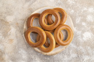 Homemade Ring Bagel on brown concrete background. top view, flat lay, copy space