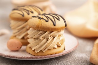 Caramel Cream Cakes on brown concrete background, cup of coffee, side view, close up, selective