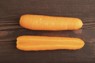 Orange Carrot on brown wooden background. Top view, close up, flat lay. healthy food, vegetable,