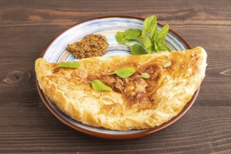 Fried homemade Khachapuri cake with cheese and meat, fried in pan. Traditional Georgian cuisine on