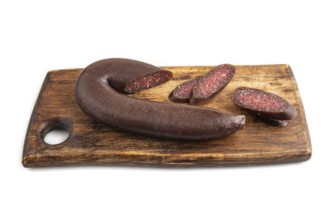 Sujuk sausage isolated on wooden cutting board on white background. Side view, copy space