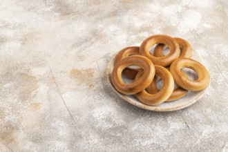 Homemade Ring Bagel on brown concrete background. side view, copy space
