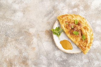 Fried homemade Khachapuri cake with cheese and meat, fried in pan. Traditional Georgian cuisine on