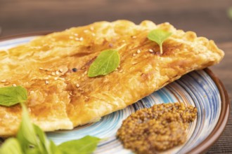 Fried homemade Khachapuri cake with cheese and meat, fried in pan. Traditional Georgian cuisine on