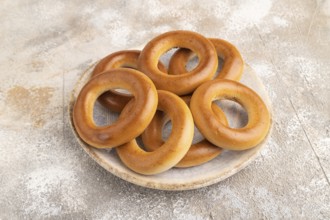 Homemade Ring Bagel on brown concrete background. side view, close up