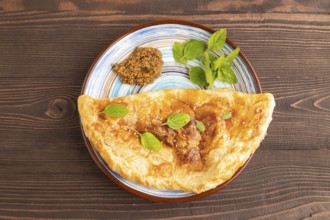 Fried homemade Khachapuri cake with cheese and meat, fried in pan. Traditional Georgian cuisine on