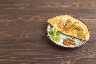 Fried homemade Khachapuri cake with cheese and meat, fried in pan. Traditional Georgian cuisine on