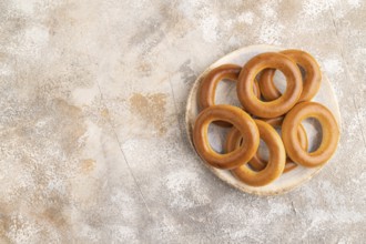 Homemade Ring Bagel on brown concrete background. top view, flat lay, copy space