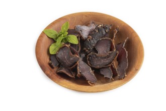 Armenian Basturma dried meat on wooden bowl isolated on white background. Side view