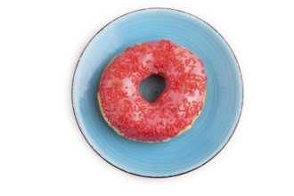 Pink Donut with sprinkles on blue ceramic plate isolated on white background, top view, flat lay,