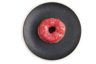 Pink Donut with sprinkles on blue ceramic plate isolated on white background, top view, flat lay,