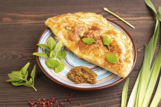 Fried homemade Khachapuri cake with cheese and meat, fried in pan. Traditional Georgian cuisine on