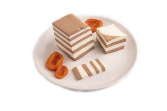 Cocoa and milk jelly with dried apricots isolated on white background, side view, minimalism