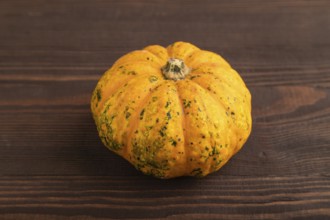 Orange Pumpkin on brown wooden background. Side view, copy space. healthy food, vegetable,