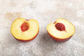 Peach Cut in half on brown concrete background. Side view, close up. healthy food, vegetable,