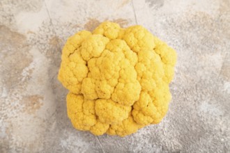 Yellow Cauliflower on brown concrete background. Top view, close up, flat lay. healthy food,