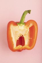 Red Cutted pepper on pink pastel background. Top view, flat lay, copy space. Tropical, healthy