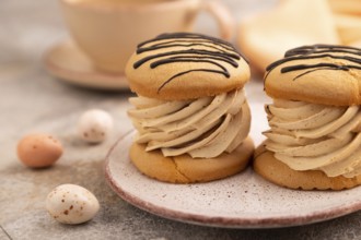 Caramel Cream Cakes on brown concrete background, cup of coffee, side view, close up, selective