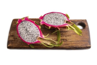 Ripe Pitaya on cutting board isolated on white background, side view, close up, minimalism