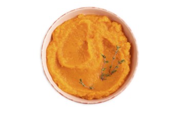 Sweet potato porridge in ceramic bowl isolated on white background. Diet, healthy eating concept.