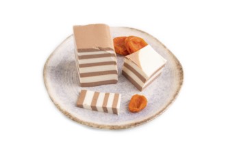 Cocoa and milk jelly with dried apricots isolated on white background, side view, minimalism