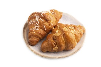 Croissant on blue plate isolated on white background, side view, close up