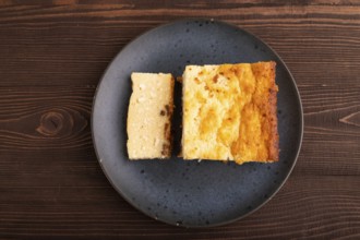 ?ottage cheese ?asserole, Curd cake, with dried apricots and raisins on brown wooden background,