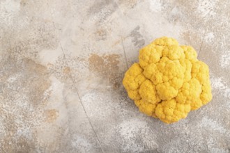 Yellow Cauliflower on brown concrete background. Top view, copy space, flat lay. healthy food,