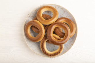 Homemade Ring Bagel on white wooden background. top view, flat lay, copy space