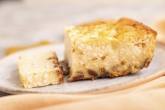 ?ottage cheese ?asserole, Curd cake, with dried apricots and raisins on brown concrete background