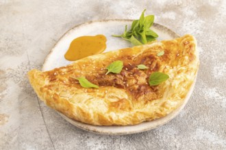 Fried homemade Khachapuri cake with cheese and meat, fried in pan. Traditional Georgian cuisine on